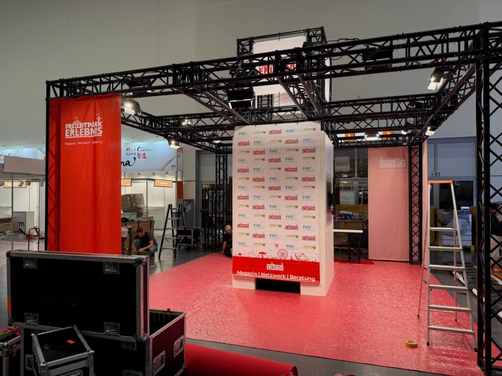 Messestand mit Traversensystem in schwarz auf rotem Teppich